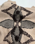 Beige knit sweater with large black geometric floral intarsia