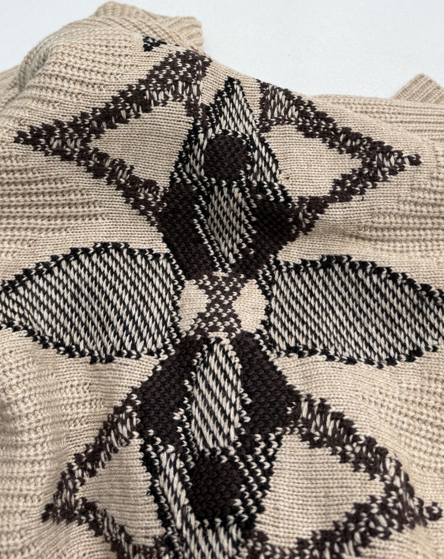 Beige knit sweater with large black geometric floral intarsia