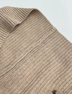 Beige knit sweater shoulder with ribbed texture