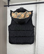 Black hooded puffer vest with plaid-lined inner hood, back view