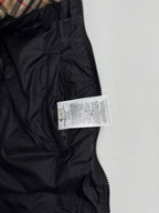 Black long puffer jacket with zip, high collar, and size label