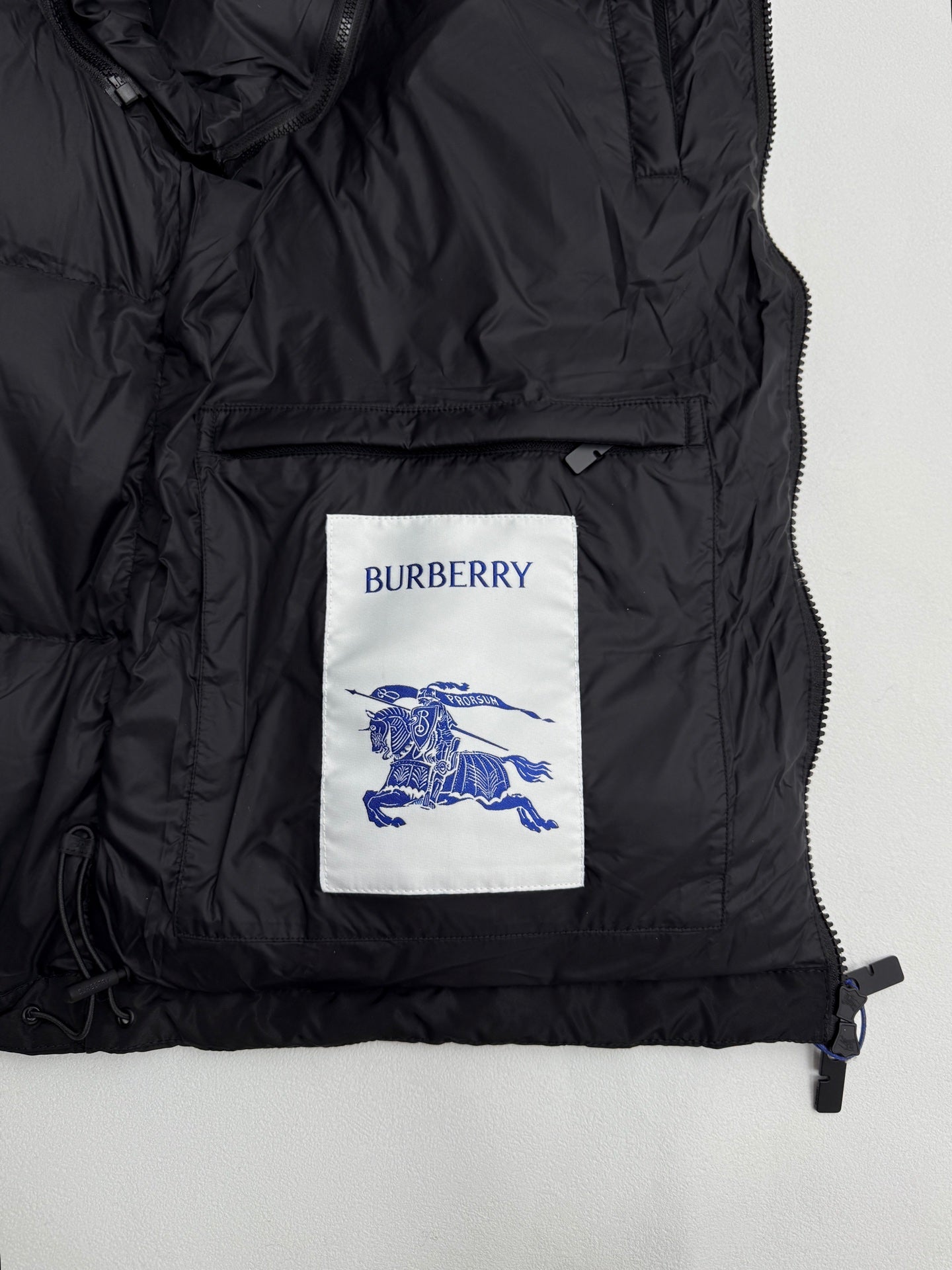 Black long puffer jacket front panel with Burberry logo patch and zip