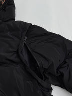 Black jacket zipper and quilted fabric detail on a padded sleeve
