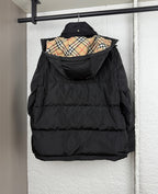 Black hooded puffer jacket with plaid-lined inner hood, front view