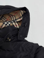 Black jacket cuff and plaid hood lining with snap and drawstring detail