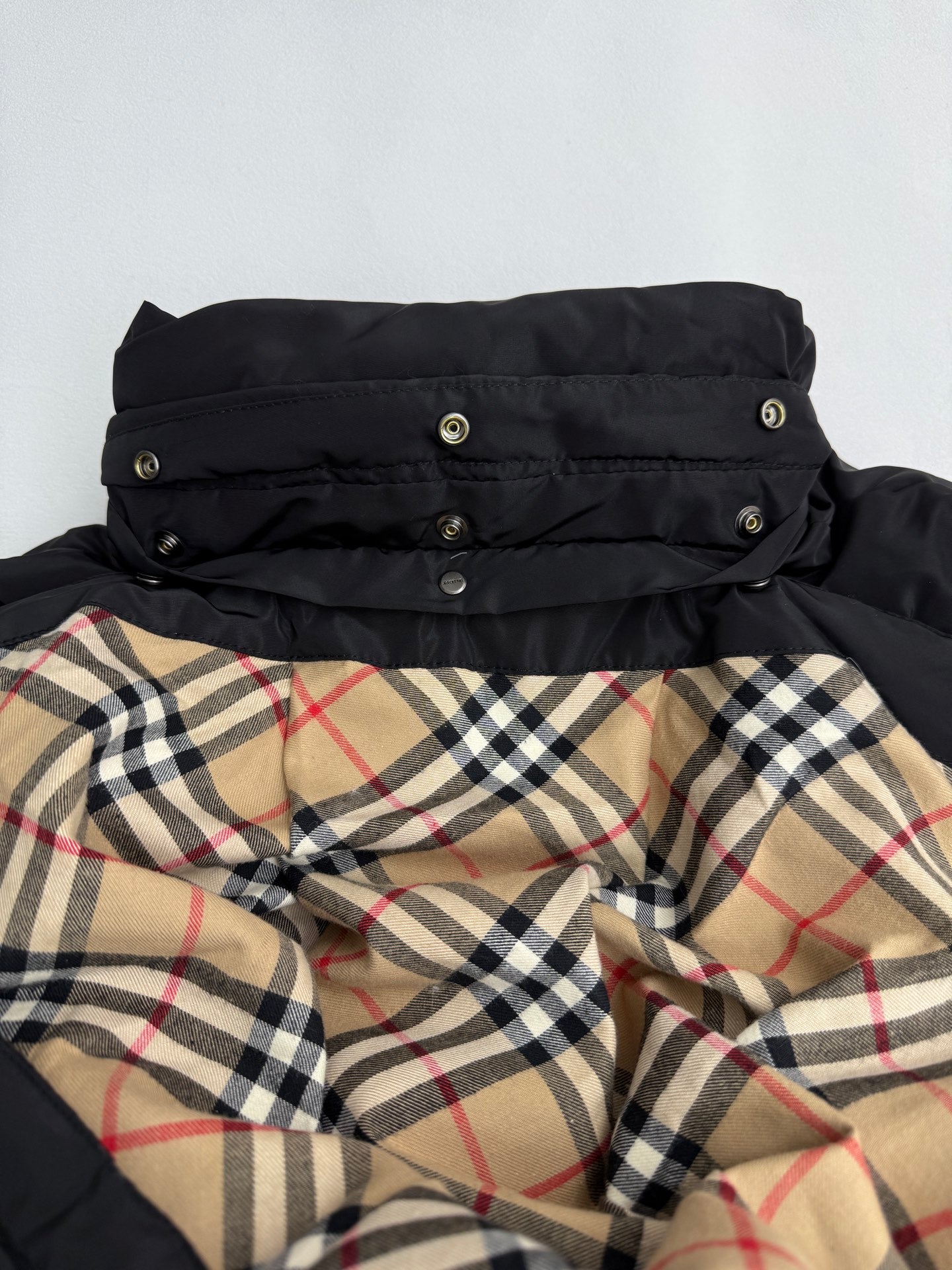 Black long puffer jacket with hood and plaid inner lining