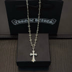 Silver-tone cross pendant necklace with floral beaded chain links