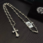 Two silver-tone cross pendant necklaces with floral chain links