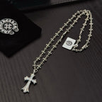 Silver-tone cross pendant necklace with floral link chain and small cross charm
