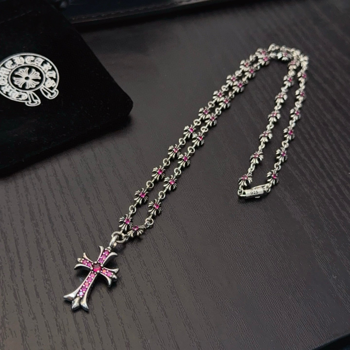 Silver-tone cross pendant necklaces with pink crystal details, two strands shown