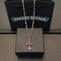 Silver-tone cross pendant necklace with pink crystal center and chain links