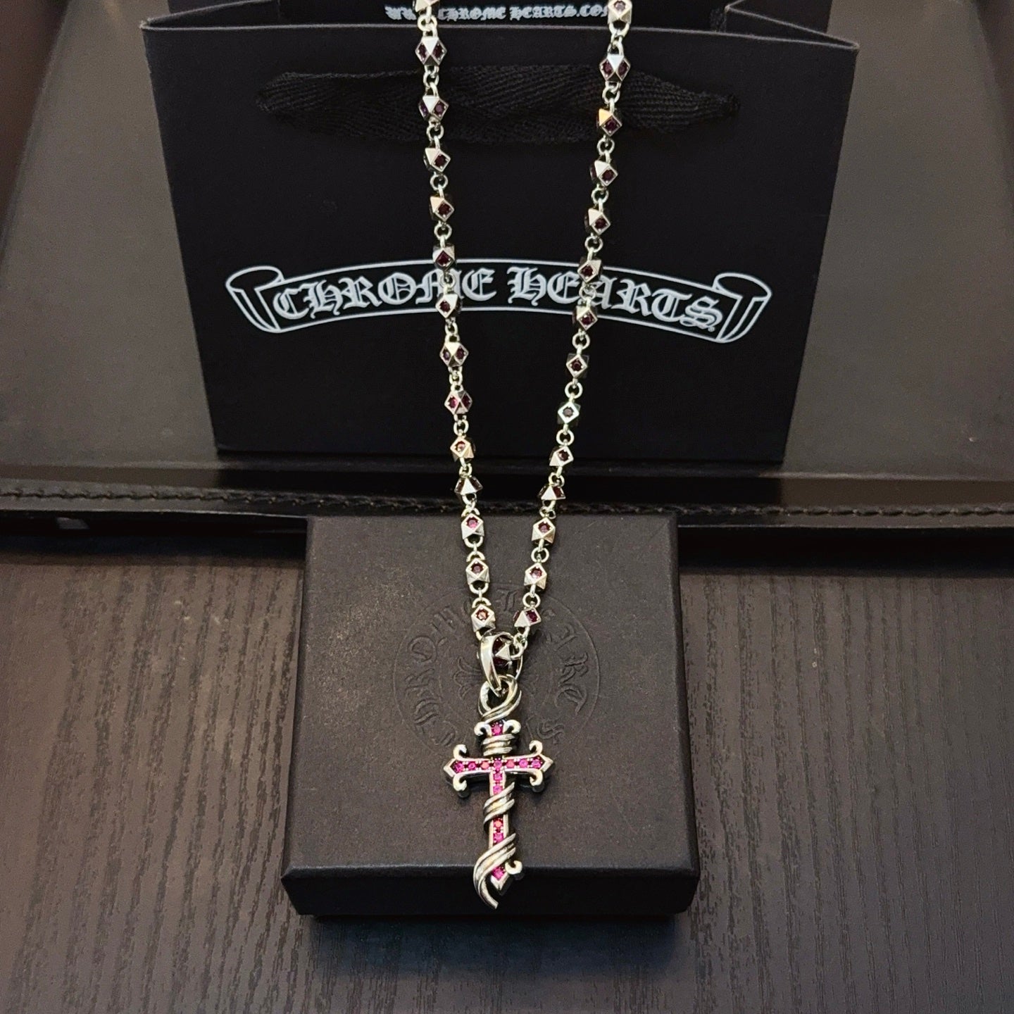 Silver cross pendant necklace with chain and pink enamel accents