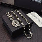 Chrome pendant necklace duo with round cross emblem charms on silver-toned chains