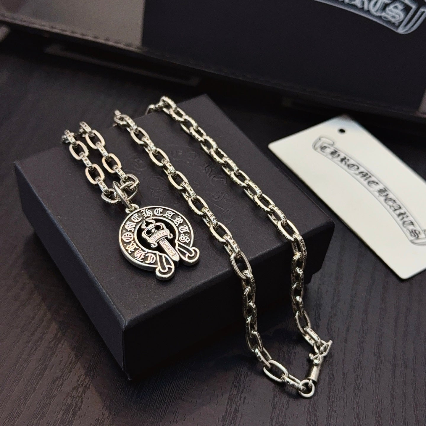 Chrome pendant necklace duo with round cross emblem charms on silver-toned chains