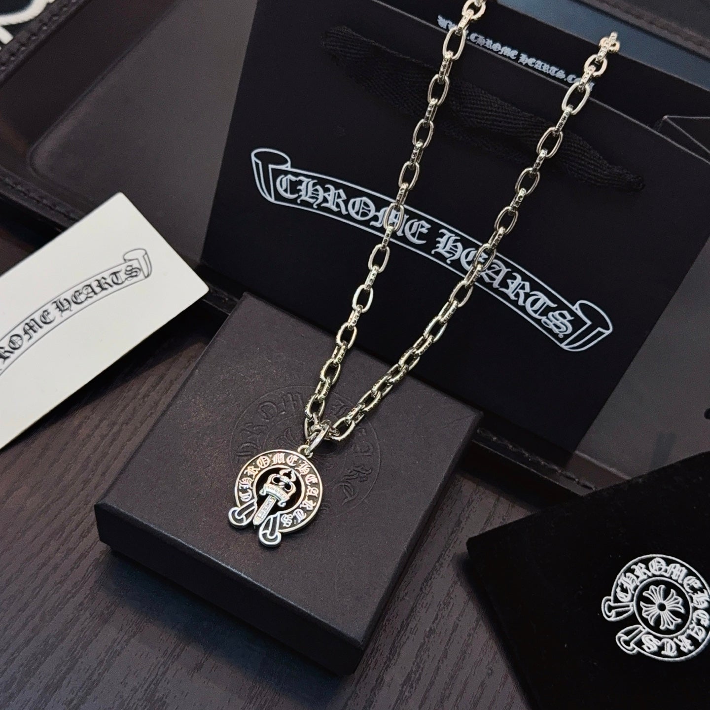 Chrome pendant necklace set with round cross emblem charms on silver-toned links