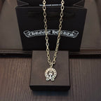 Chrome pendant necklace with round cross emblem pendant on silver-toned chain