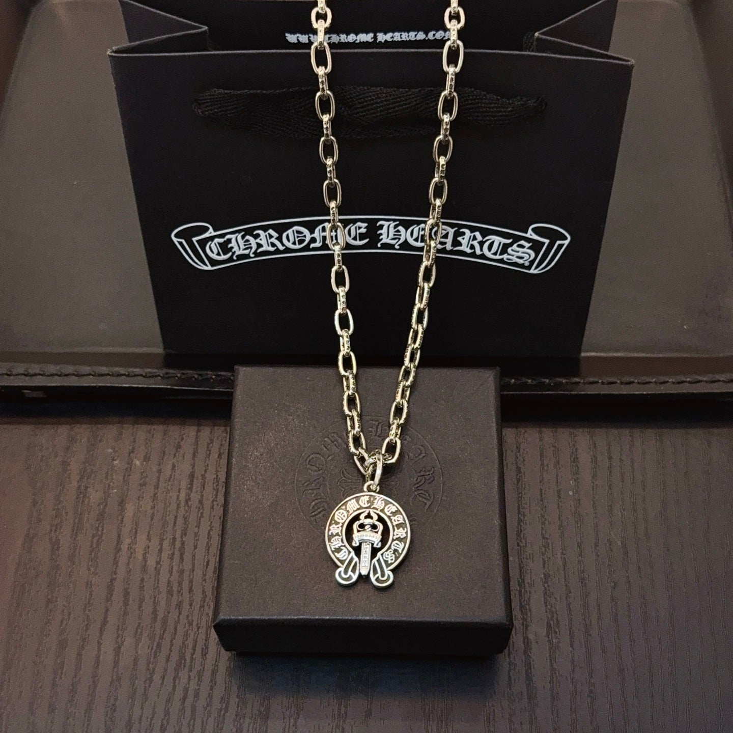 Chrome pendant necklace with round cross emblem pendant on silver-toned chain