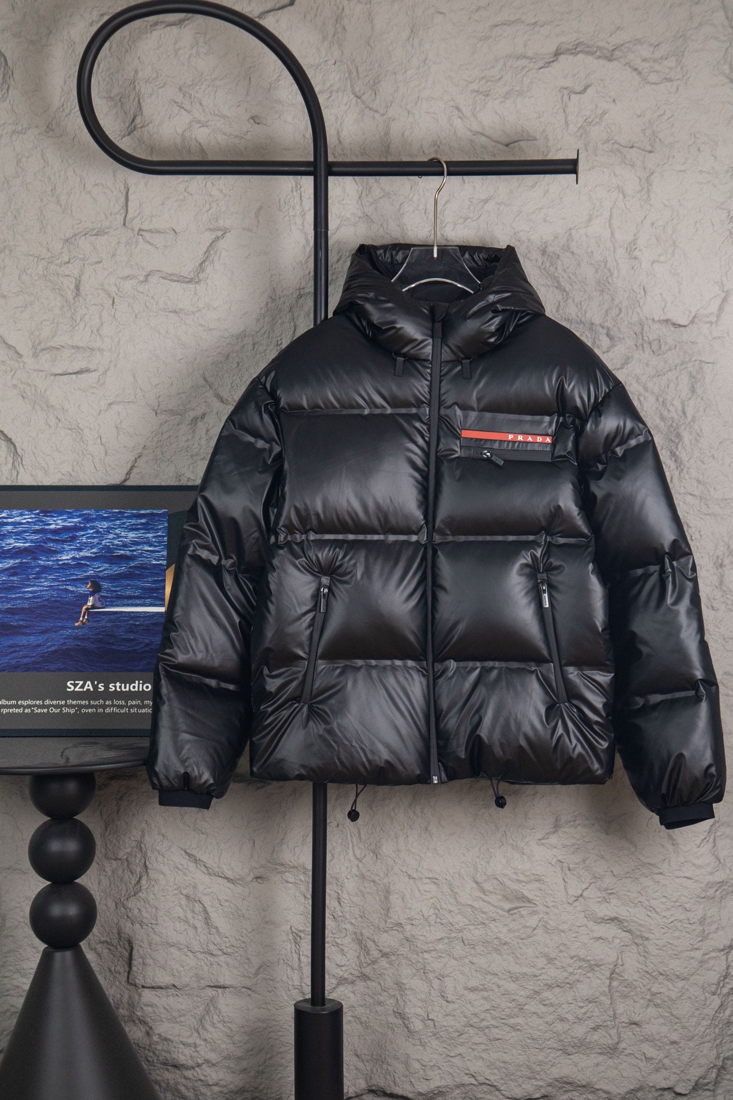 Long puffer jacket with hood, dark shell, front zip and stand collar