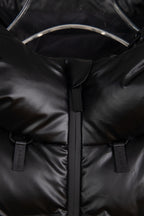 Puffer jacket close-up of front zipper and two branded snap/strap tabs