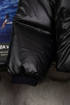 Long puffer jacket sleeve and cuffs, dark padded outer with elastic hem
