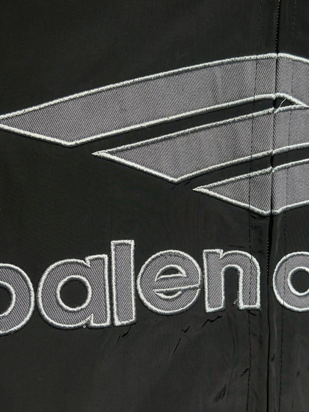 Black jacket sleeve with Balenciaga logo and stitched panel details