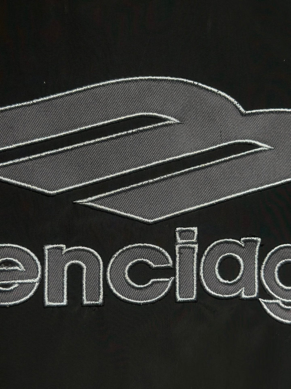 Black track jacket with embroidered Balenciaga logo and graphic lines