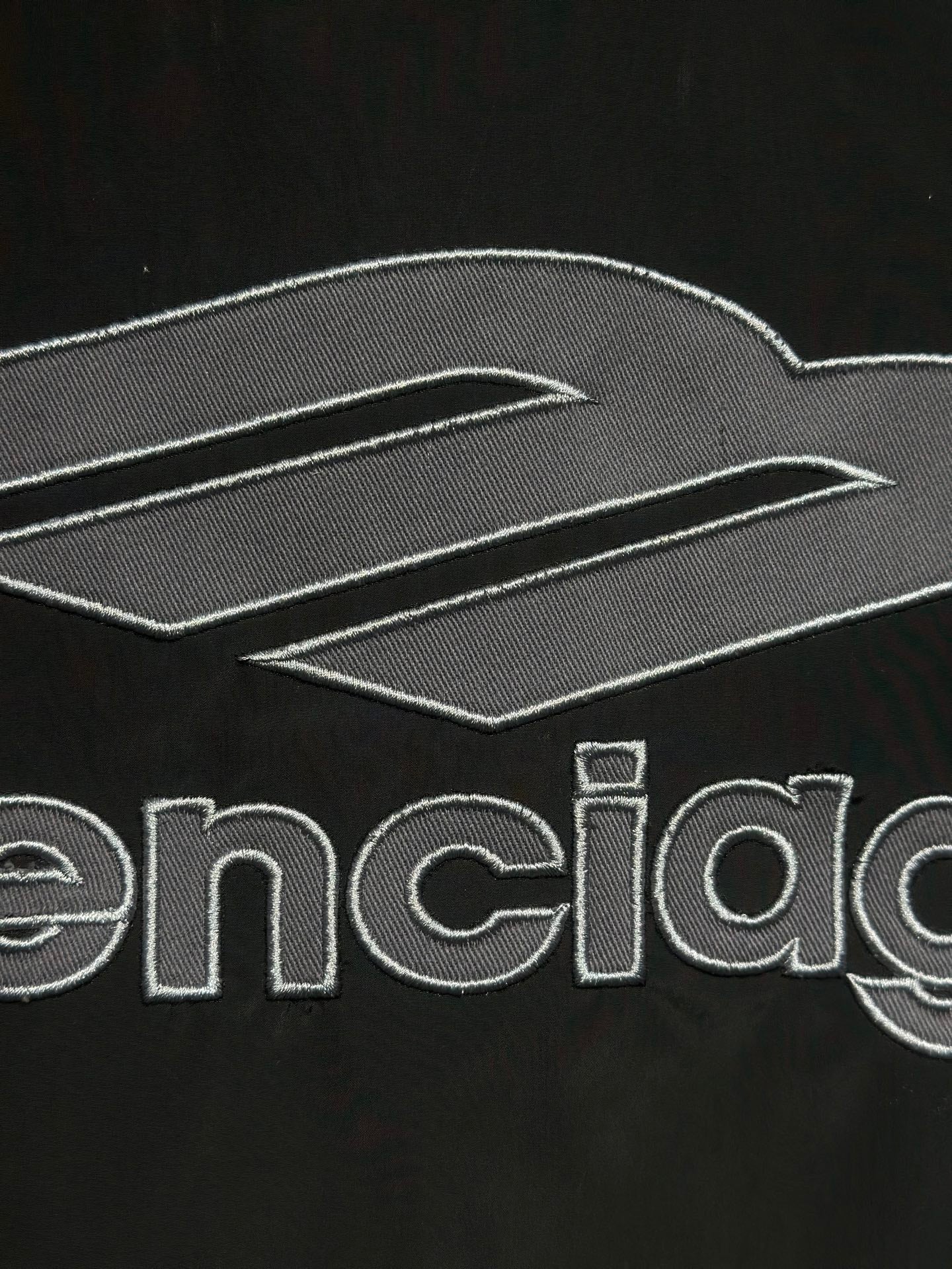 Black track jacket with embroidered Balenciaga logo and graphic lines