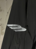 Black jacket sleeve with silver graphic logo detail