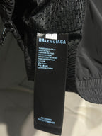 Black track jacket with interior size and care label tag
