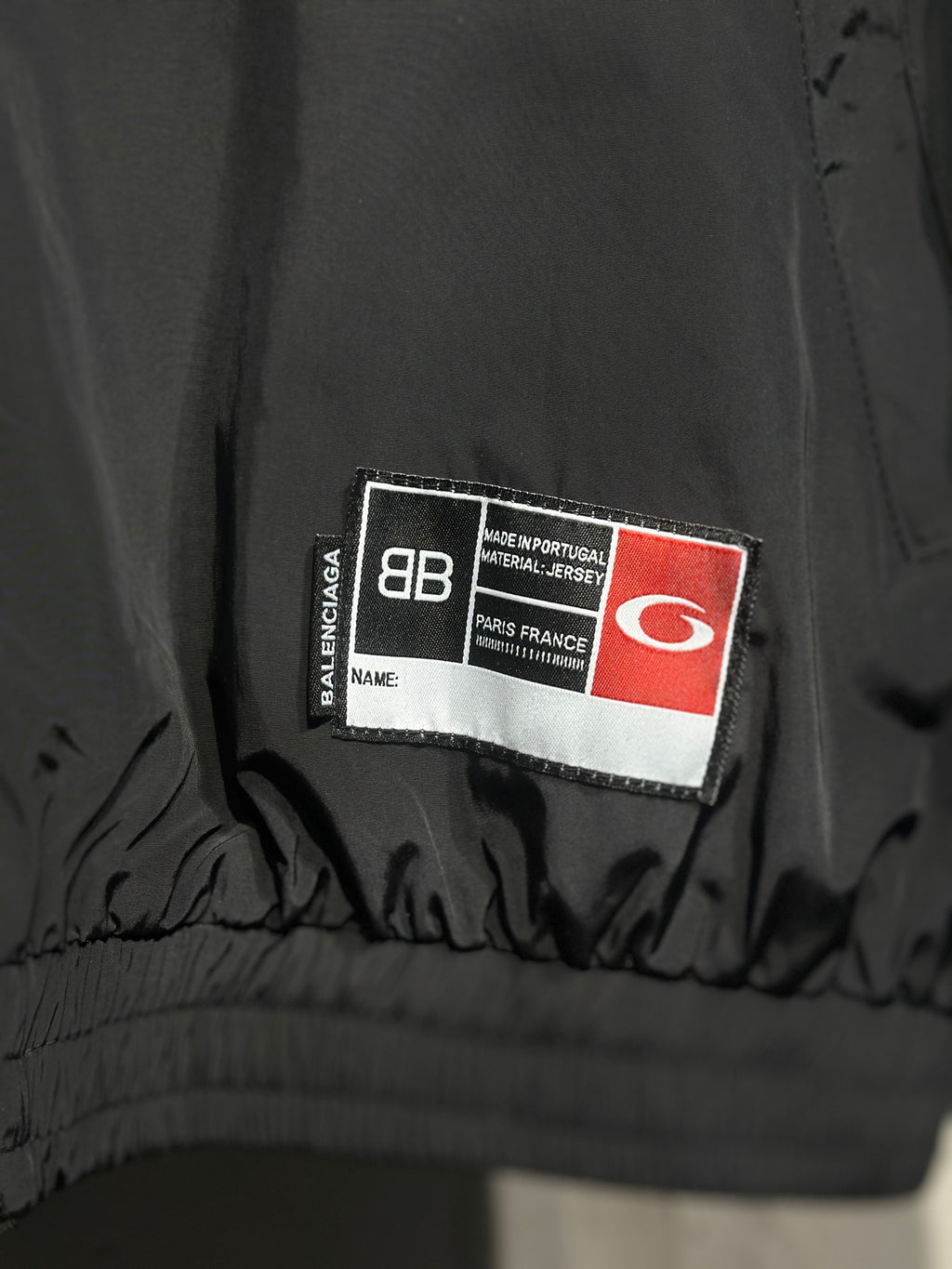 Black Balenciaga inner label at hem with size and performance tag
