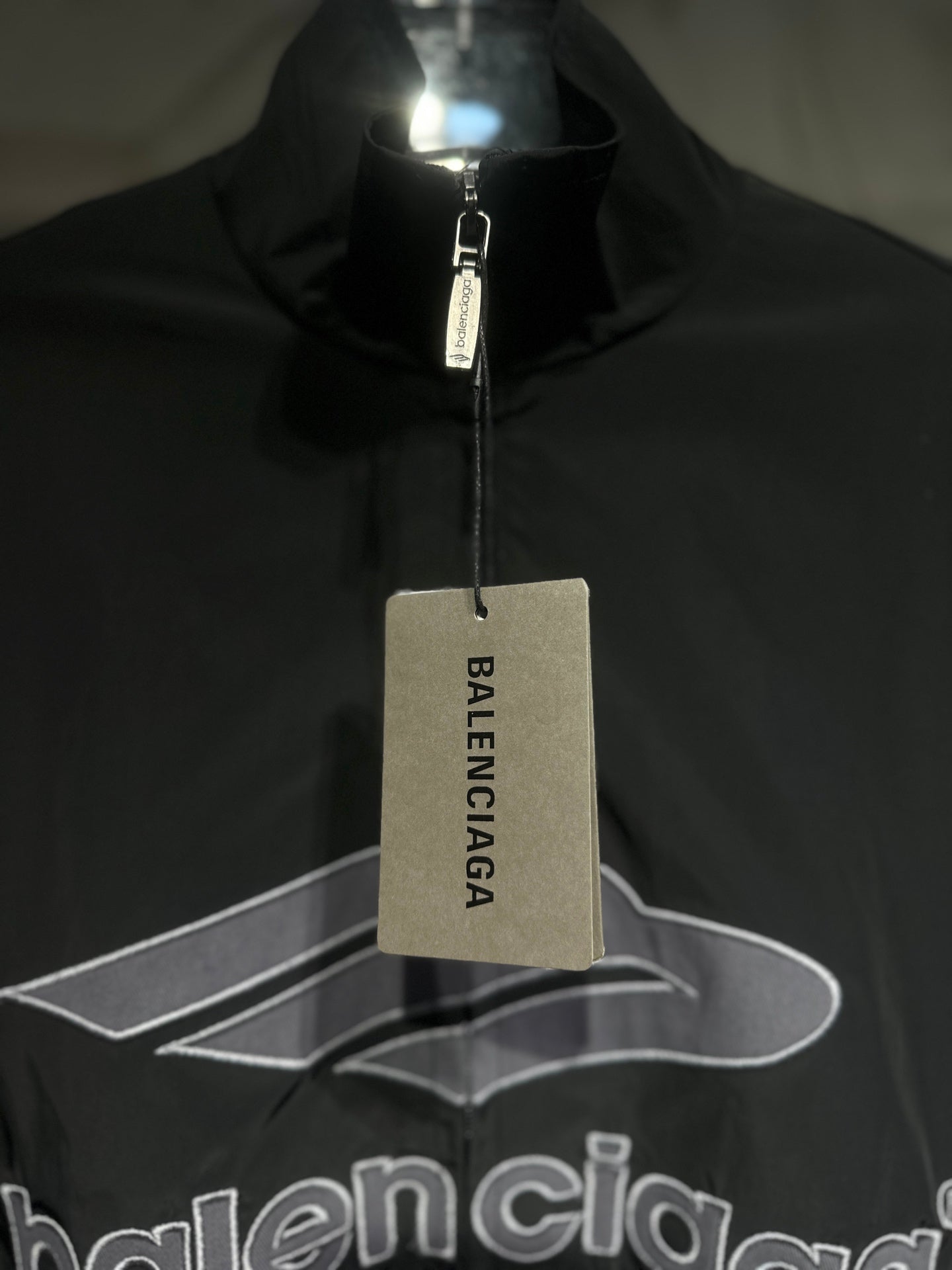 Black Balenciaga logo jacket with hang tag at the zipper
