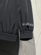 Black track jacket sleeve cuff with elastic hem and small Balenciaga logo
