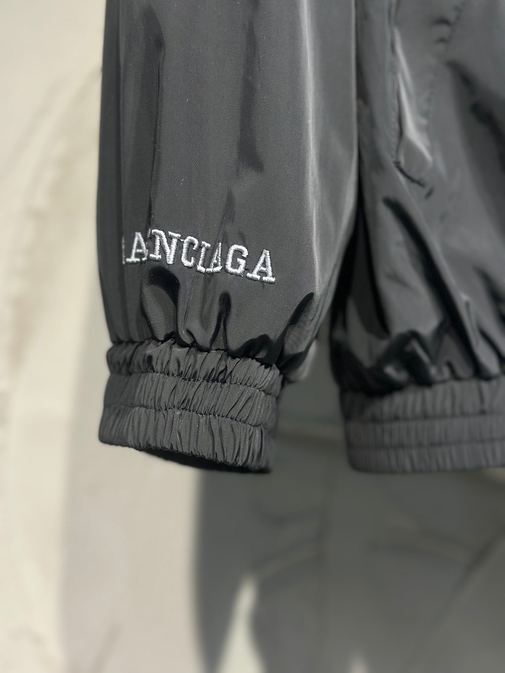 Black jacket with ribbed cuffs and small Balenciaga logo text