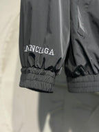 Black jacket with ribbed cuffs and small Balenciaga logo text
