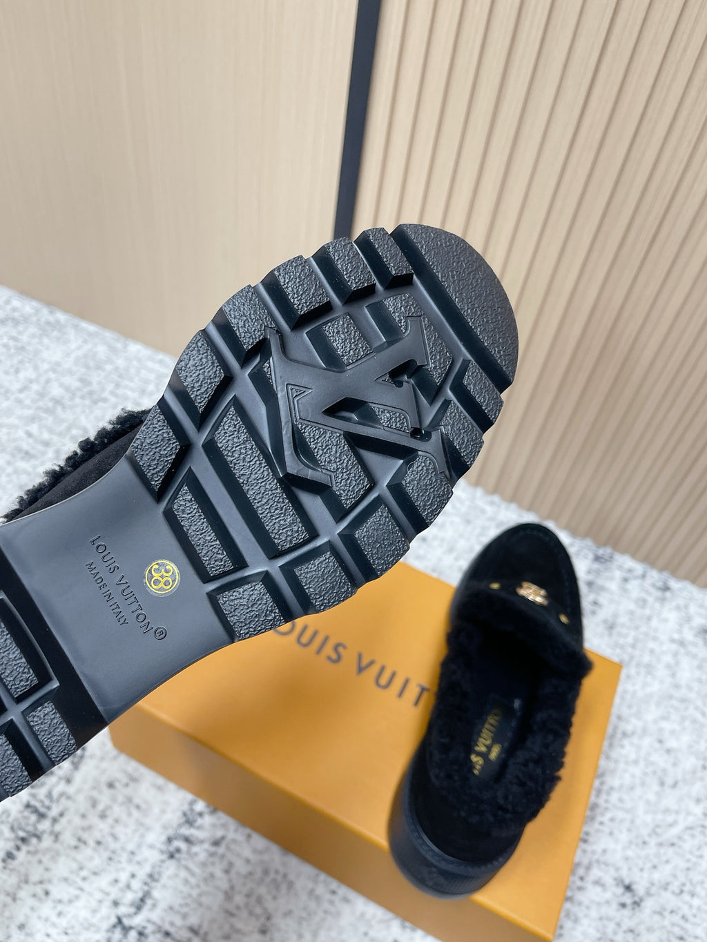 Dark rubber outsole tread of shearling-lined loafer shoes