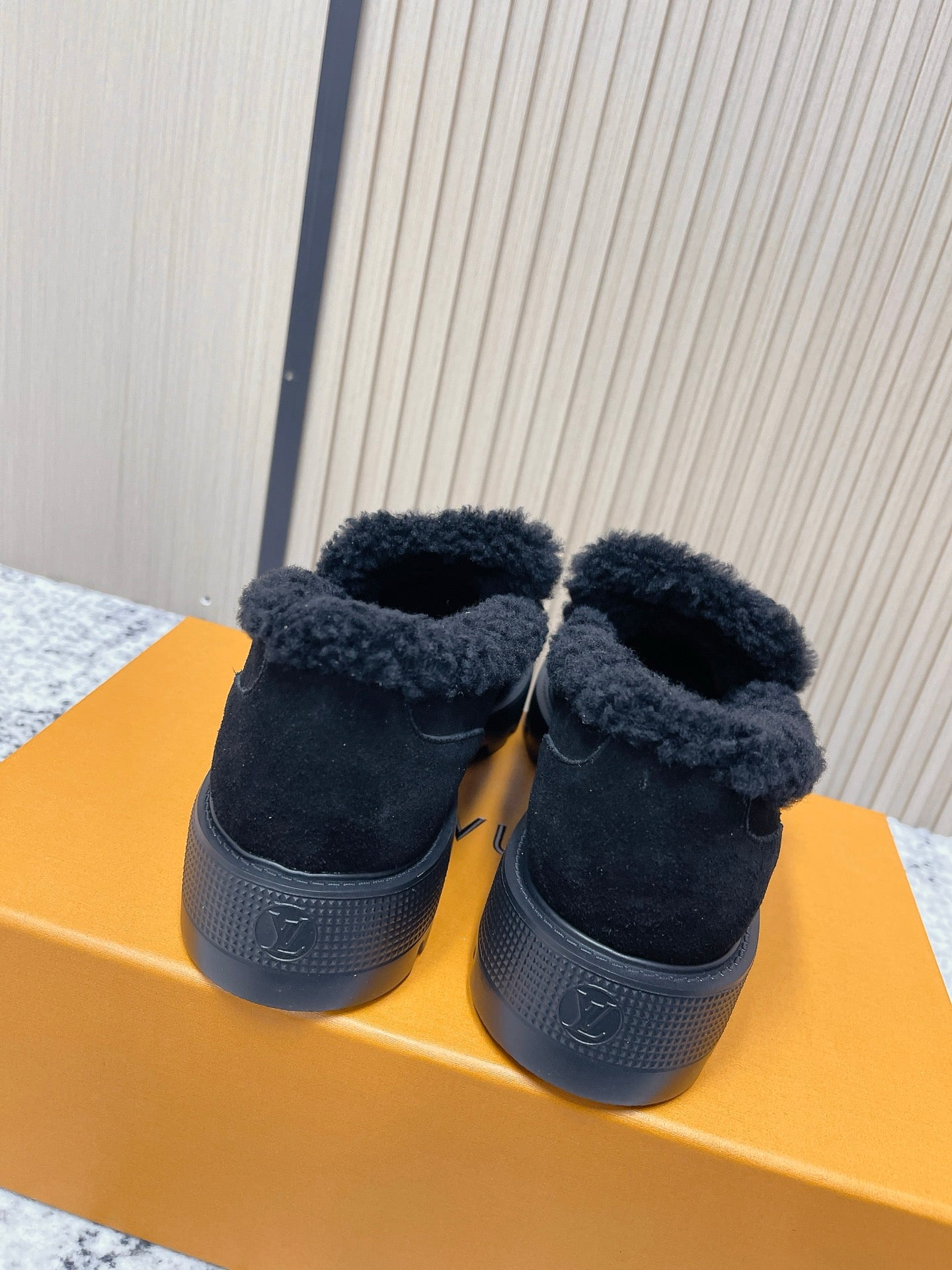 Dark suede shearling-lined loafer shoes with textured rubber heel and back view