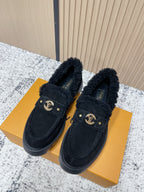 Dark suede shearling-lined loafer shoes with gold logo buckle and low rubber sole