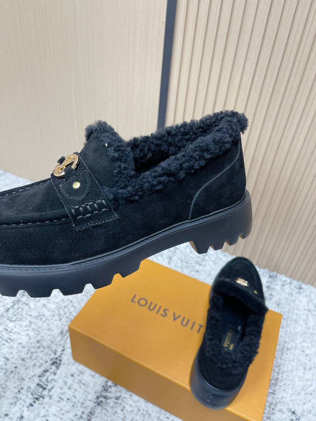 Dark suede shearling loafer shoes with gold logo buckle and grippy rubber sole tread