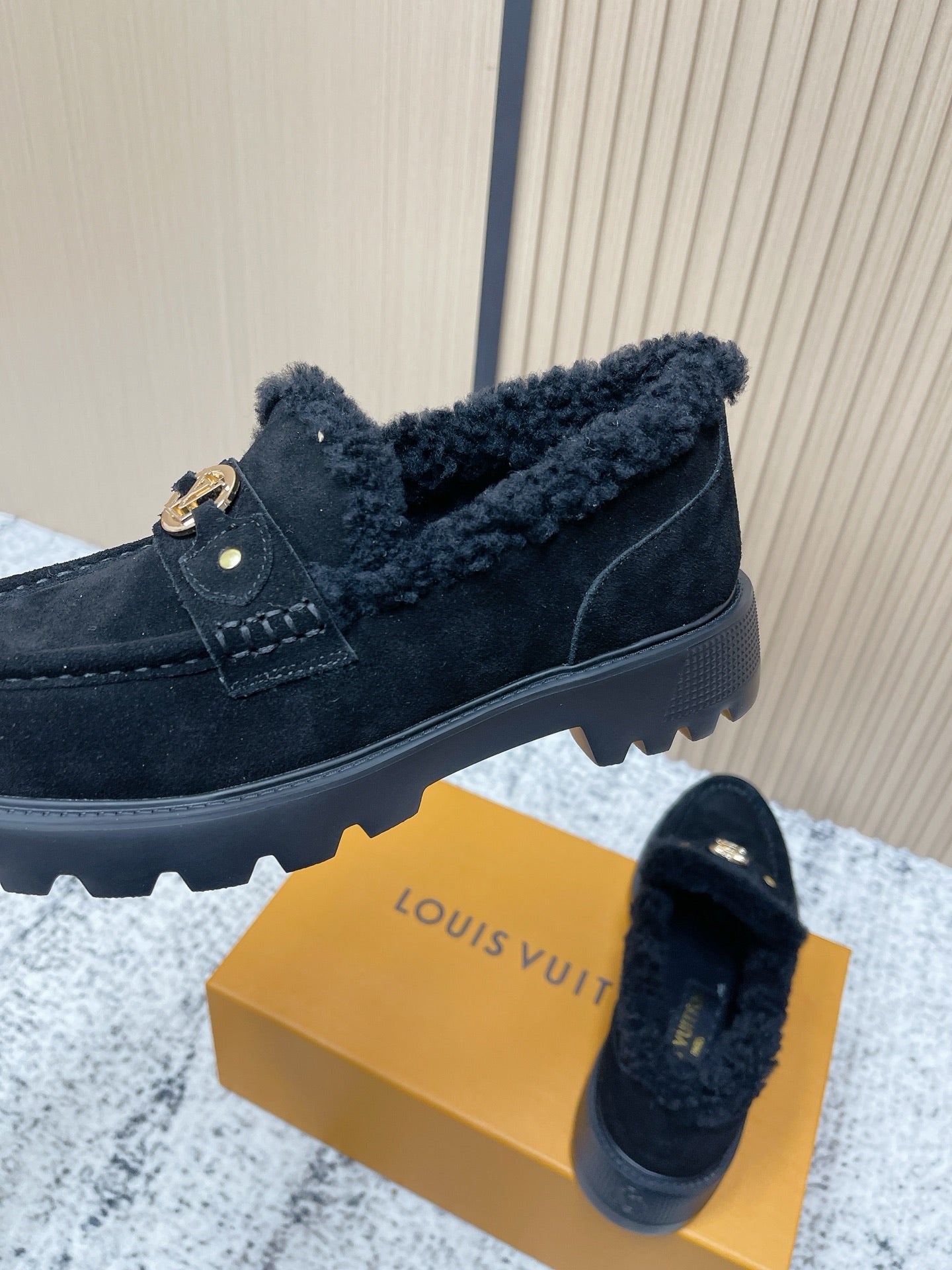Dark suede shearling loafer shoes with gold logo buckle and grippy rubber sole tread