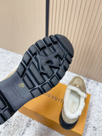 Outsole view of beige shearling shoes with textured dark rubber tread