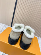 Beige suede slip-on shoes with white shearling collar and black sole
