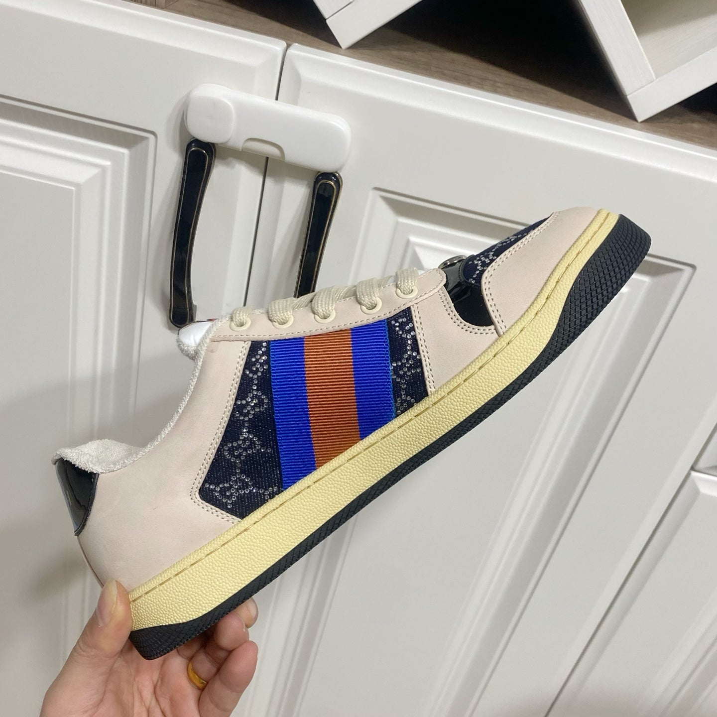 Gucci unisex sneakers on hand, cream leather with navy side stripe and yellow sole
