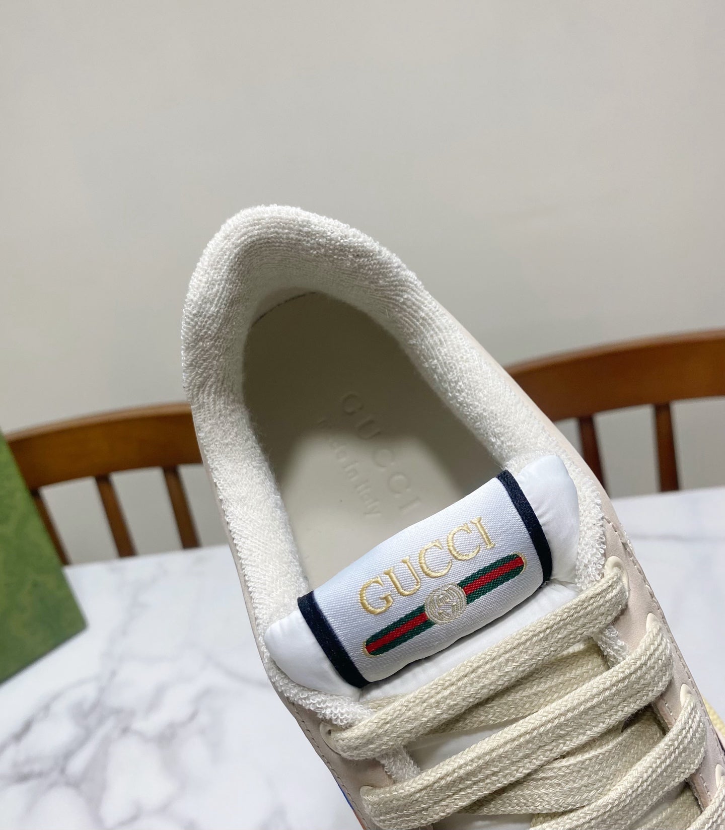 Gucci unisex sneaker heel label, cream suede collar with colorful Gucci patch