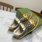 Low-top unisex sneakers in olive canvas with GG panels, multicolor stripe, and yellow accents