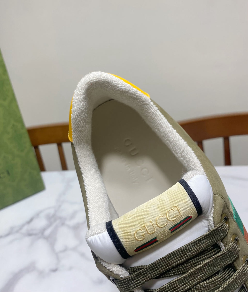 Low-top unisex sneaker heel with white lining, navy trim, and embossed logo on collar