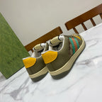 Low-top unisex sneakers, olive with multicolor side stripe and yellow lace tabs, back view