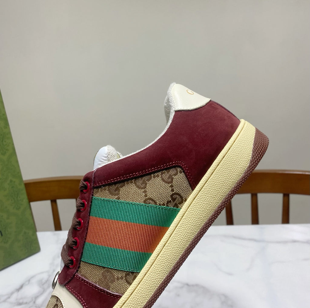 Gucci unisex sneaker upper close-up with burgundy suede, GG canvas, and striped web