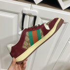 Gucci unisex sneaker side view, burgundy suede with GG canvas and striped web detail