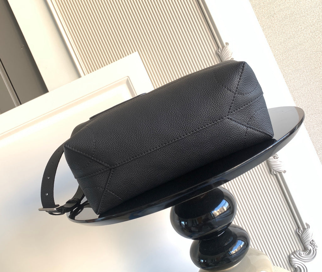 Men’s black leather bag side view with adjustable crossbody strap