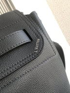 Black leather flap with engraved Louis Vuitton logo detail